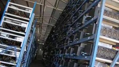 A large-scale mining farm with rows upon rows of mining machines, showcasing the scale and infrastructure required for industrial-level cryptocurrency mining.